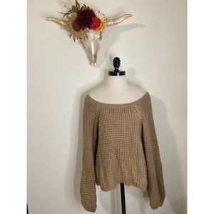 Tan knit off shoulder sweater with batwing sleeve.